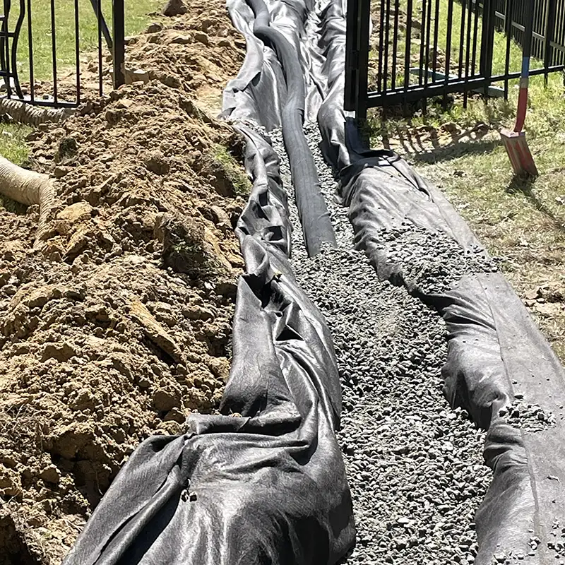 French drain installation during drainage project